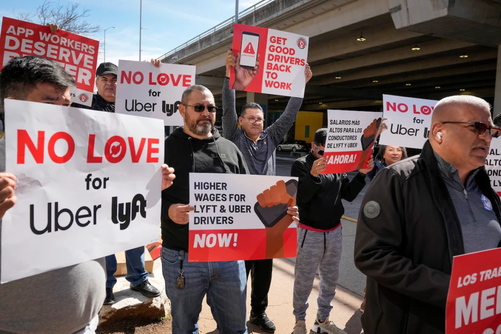 Uber and Lyft drivers rally for batter pay and working conditions at Austin-Bergstrom International Airport in Austin. (Jay Janner/AP)
